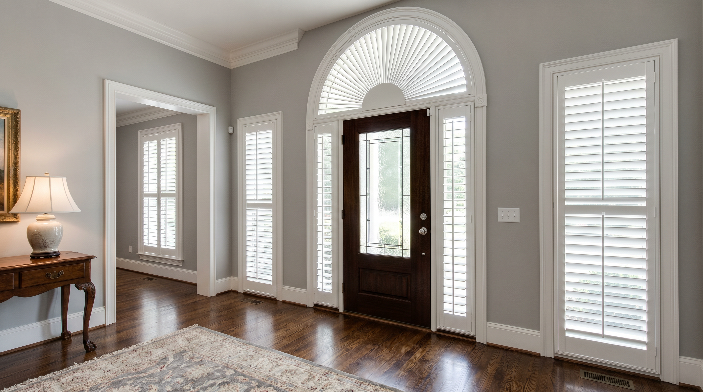 Specialty shaped window fitted with custom white plantation shutters