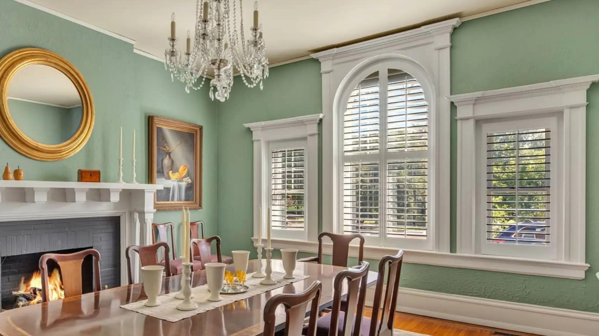 Elegant dining room with custom arched plantation shutters