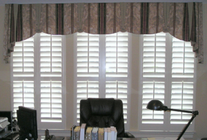 Plantation Shutters with Valance behind a Desk