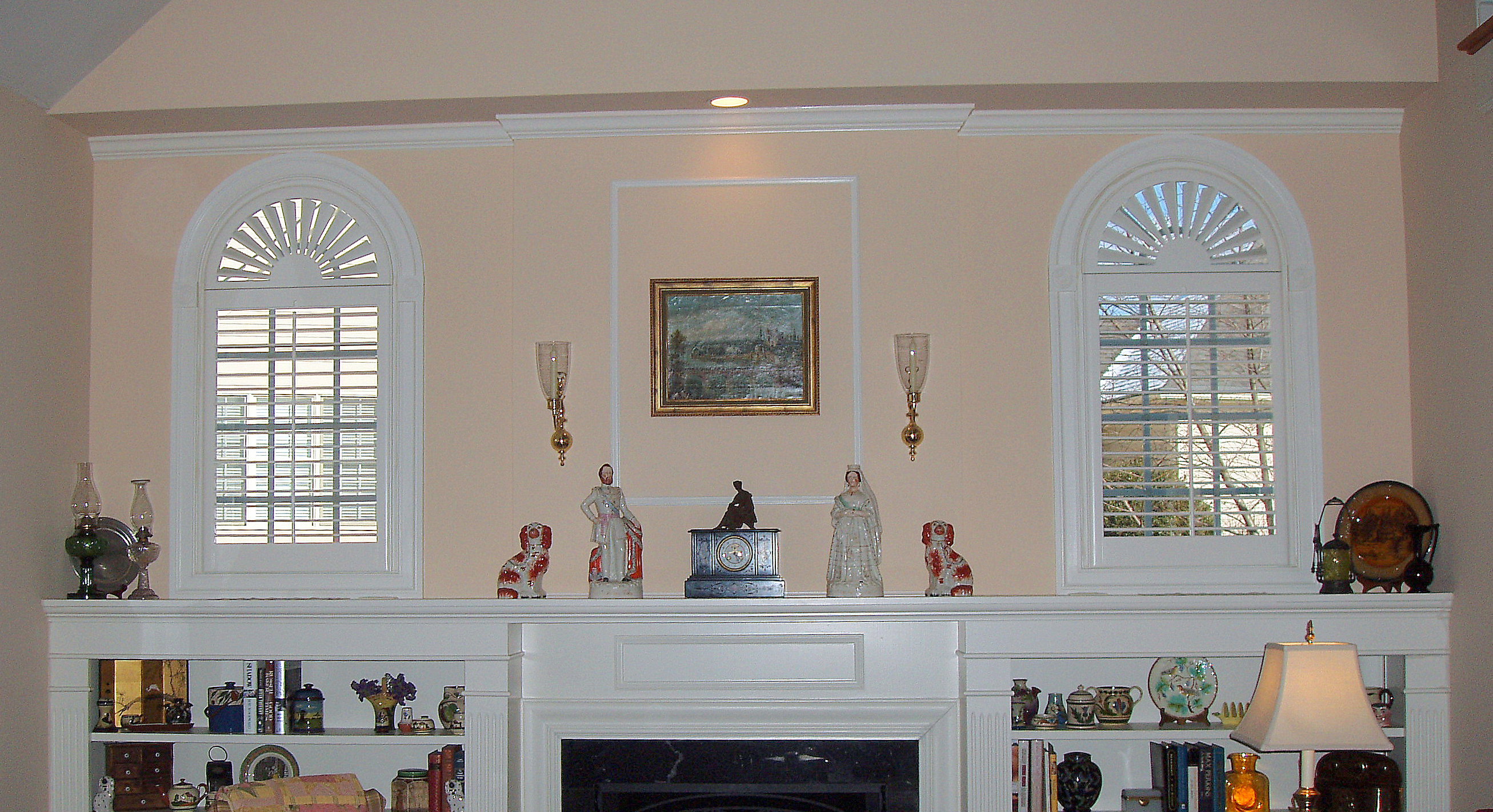 Arched Panel Plantation Shutters over fireplace